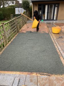 putting gravel stones to achieve a robust sub-base for astro turf
