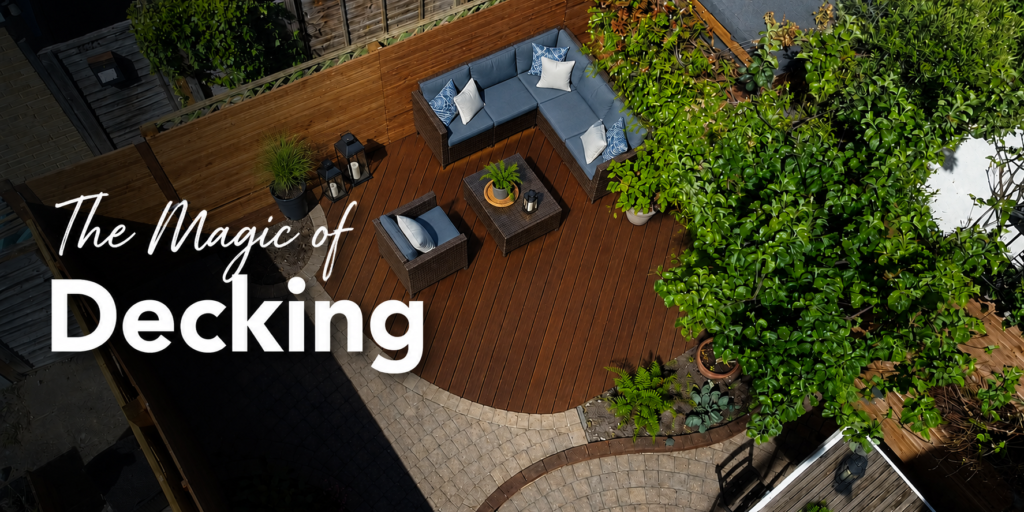 Modern timber garden decking with a comfortable blue outdoor sofa set, armchair and coffee table, creating a stylish seating area in a landscaped London garden